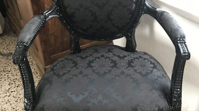 Fauteuil noir rénové pendant le stage de tapisserie ameublement
