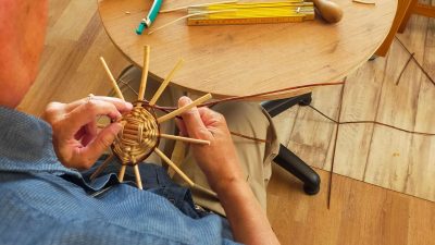 Début de panier dans l'atelier de vannerie pendant le stage avec un vannier